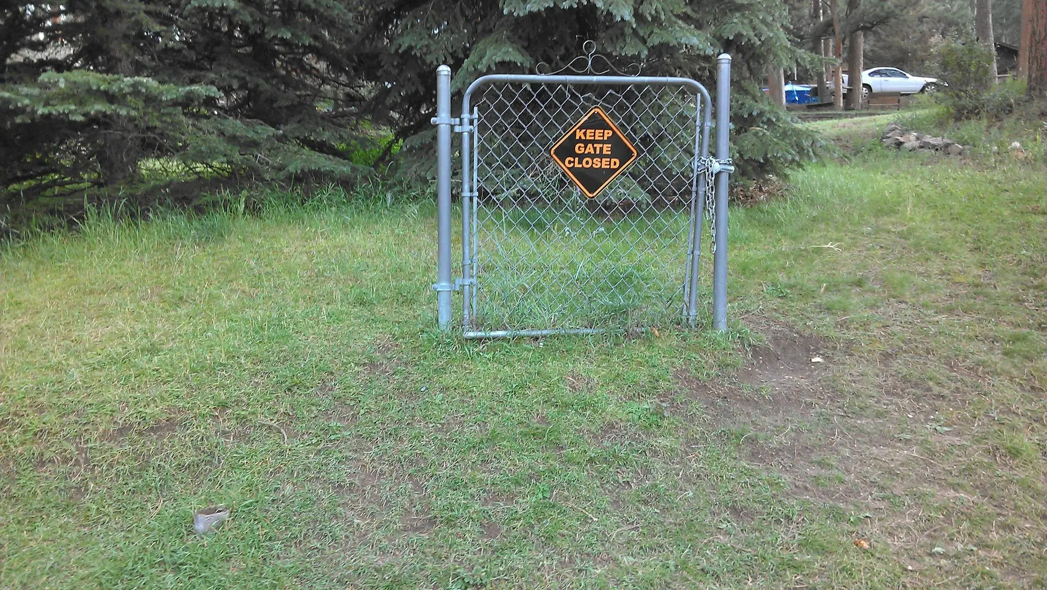 A locked gate with no fence around it